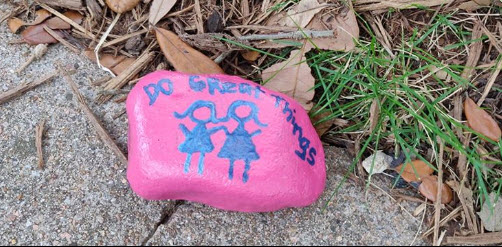 pink rock with two stick figure girls and the heading Do Great Things